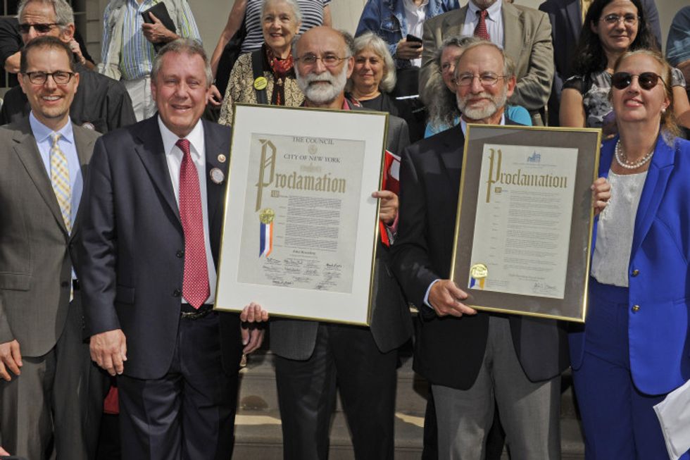 9/28/15  Robert Meeropol (pictured, pink shirt) and his brohter, Michael Meeropol, (pictured, blue shirt) received a proclamation from City Council member Daniel Dromm today.  The proclamation recognized the contributions to the labor movement of Ethel Rosenberg, the mother of Robert and Michael.  She was convicted of espionage along with her husband Julius in 1953 and was sentenced to death.  Today would have marked her 100th birthday. Pictured, left to right:  City Council member Mark Levine, City Council member Daniel Dromm, Robert Meeropol, Michael Meeropol and Gail Brewer. On the steps of City Hall, NY, NY . Please credit Gregory P. Mango.