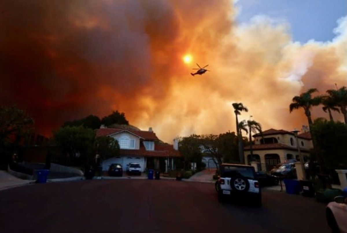 Wildfire sparks panicked evacuations in Los Angeles suburbs