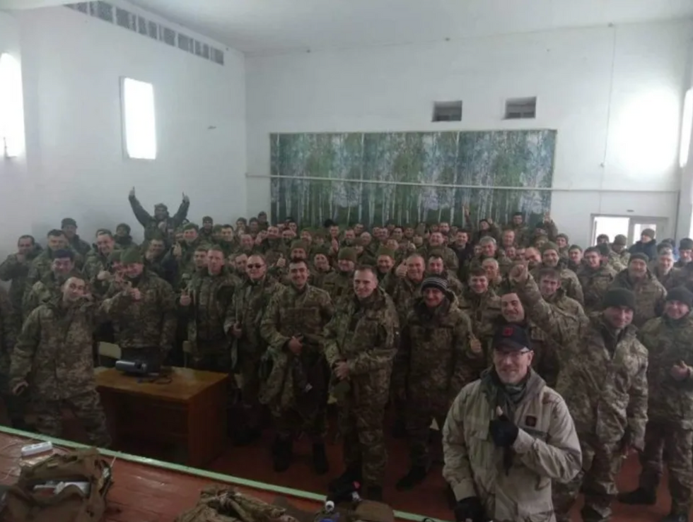 Aaron Harford (foreground, right) poses with other Right Sector volunteers in Ukraine. (courtesy image)