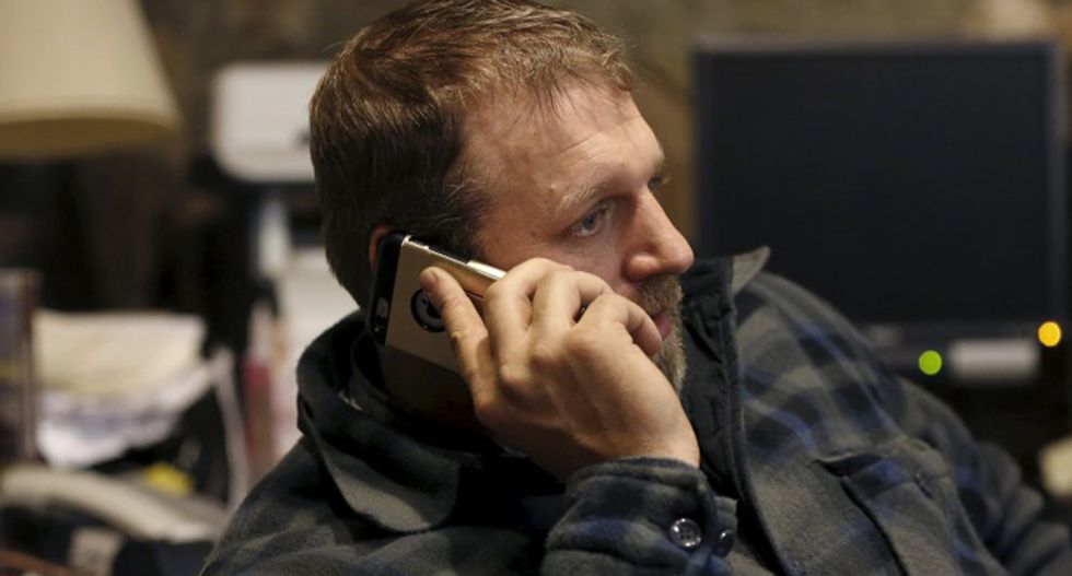 Ammon Bundy talks on the phone in an office at the Malheur National Wildlife Refuge near Burns, Oregon, January 5, 2016. (REUTERS/Jim Urquhart)