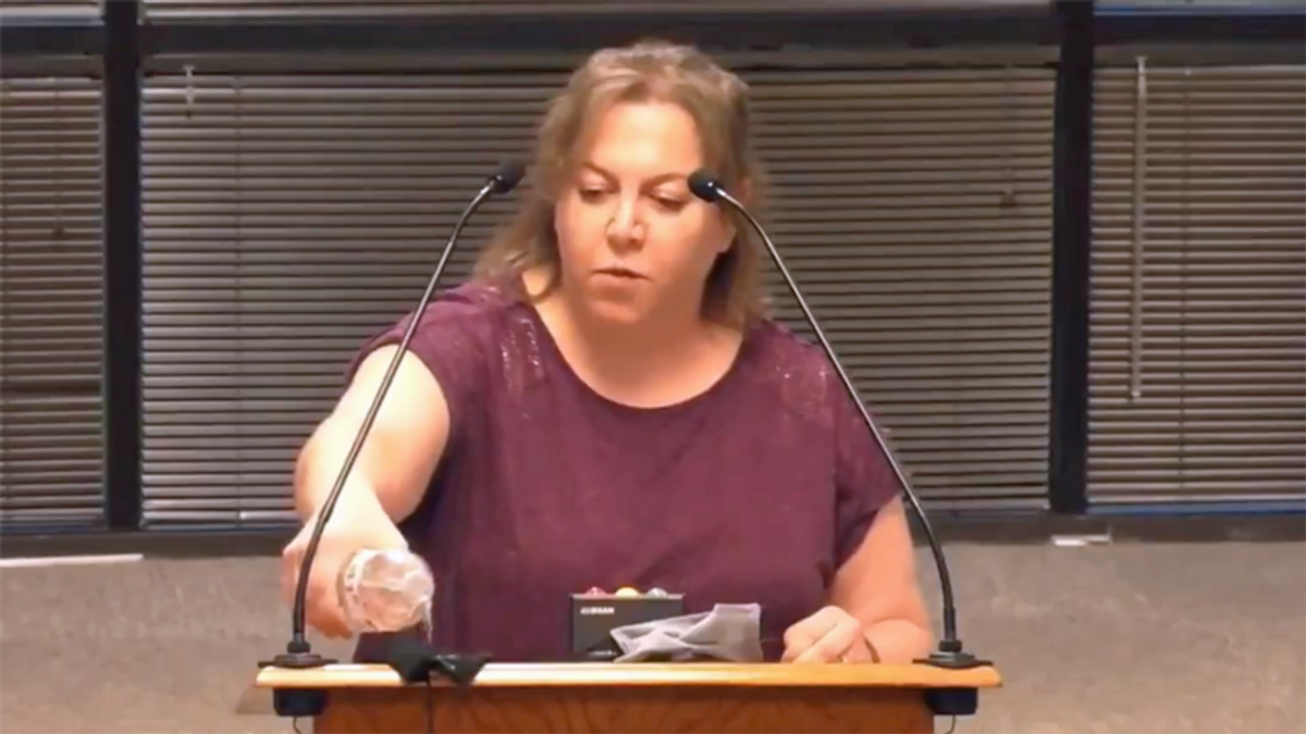 WATCH: Anti-masker douses mask with water and smears it on surface during angry rant about germs