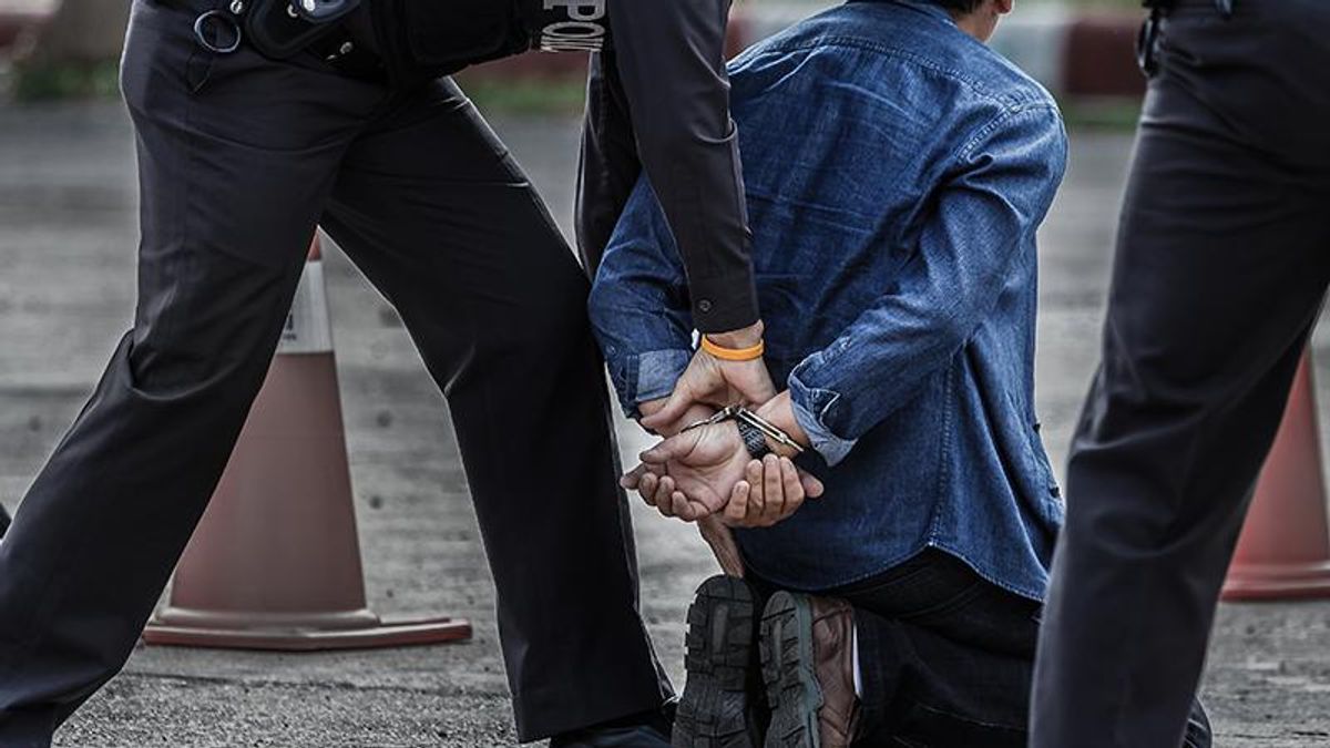 arrested man handcffed