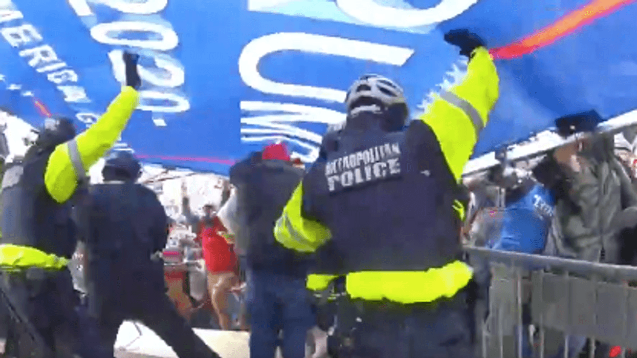 New video shows Capitol rioters using Trump banner as battering ram against police
