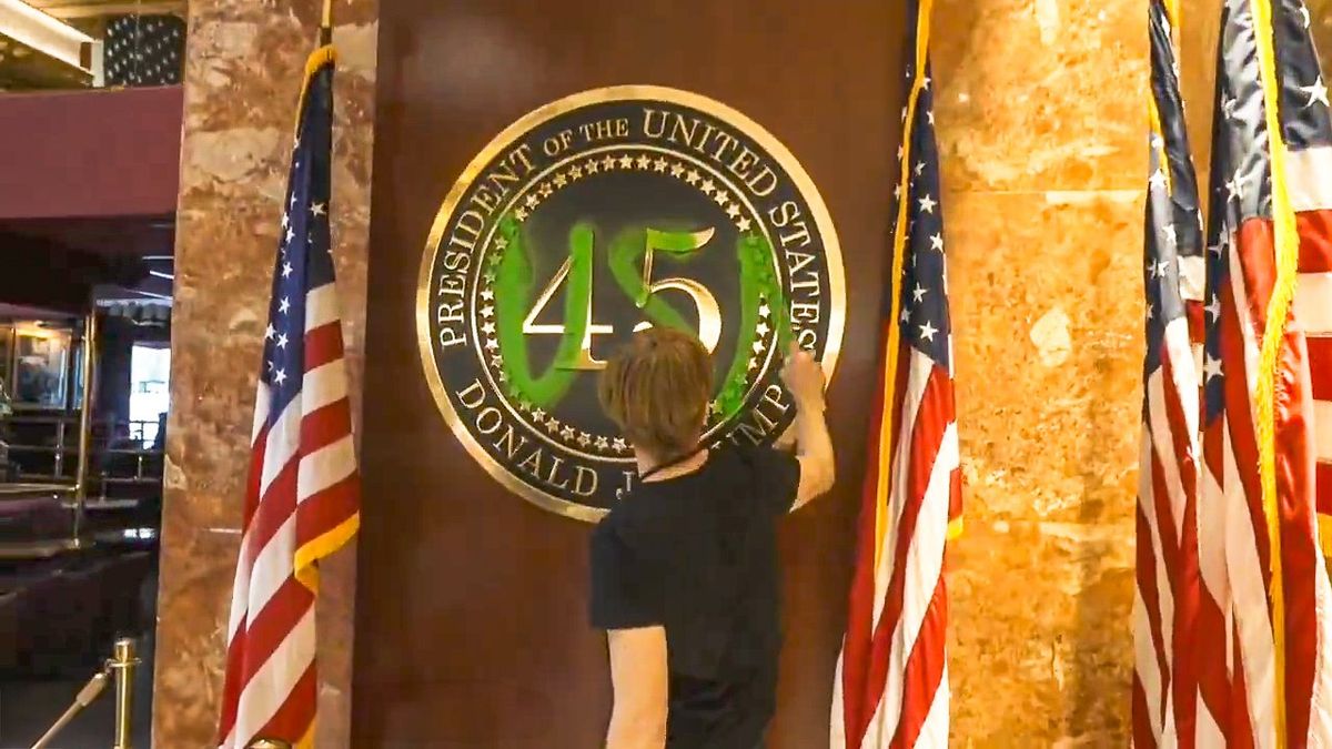 Activist handcuffed by Secret Service after defacing presidential placard in Trump Tower