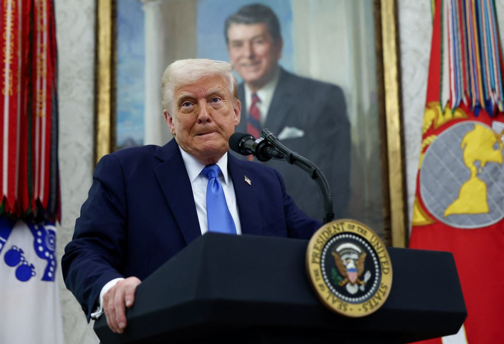 Donald Trump and a portrait of Ronald Reagan