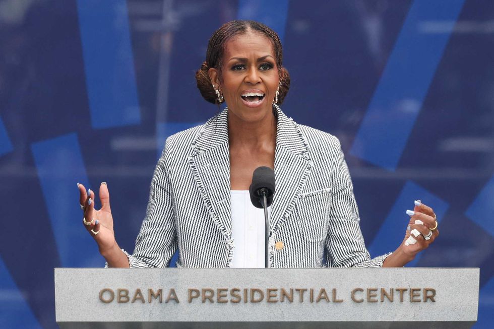 Chicago crowd cheers as Michelle Obama jabs Trump