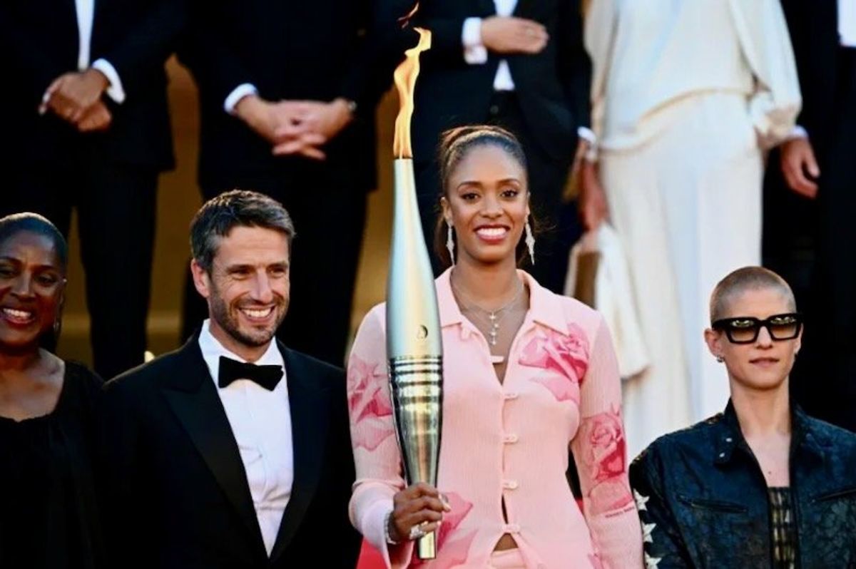 Olympic torch ascends Cannes red carpet
