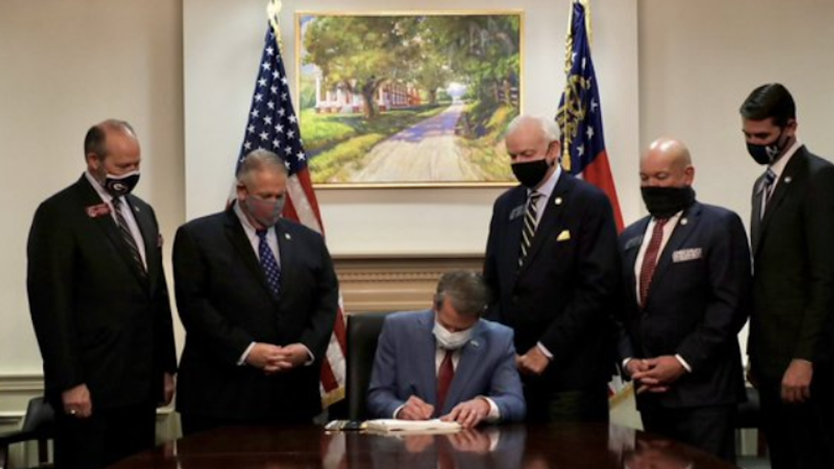 Georgia governor signed Jim Crow-style voting legislation beneath painting of notorious plantation