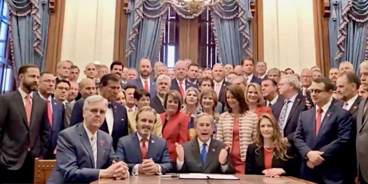 'New season of The Handmaid's Tale': Texas Gov. Abbott slammed as he signs abortion ban surrounded by 50 men and 8 women