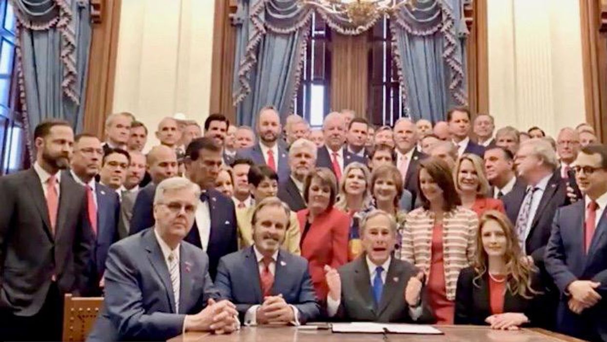 'New season of The Handmaid's Tale': Texas Gov. Abbott slammed as he signs abortion ban surrounded by 50 men and 8 women