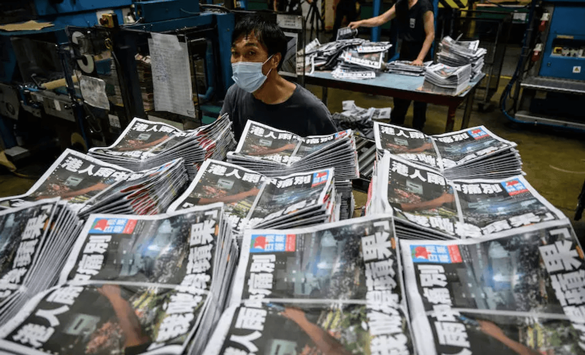 Hong Kong police arrest top writer from shuttered Apple Daily