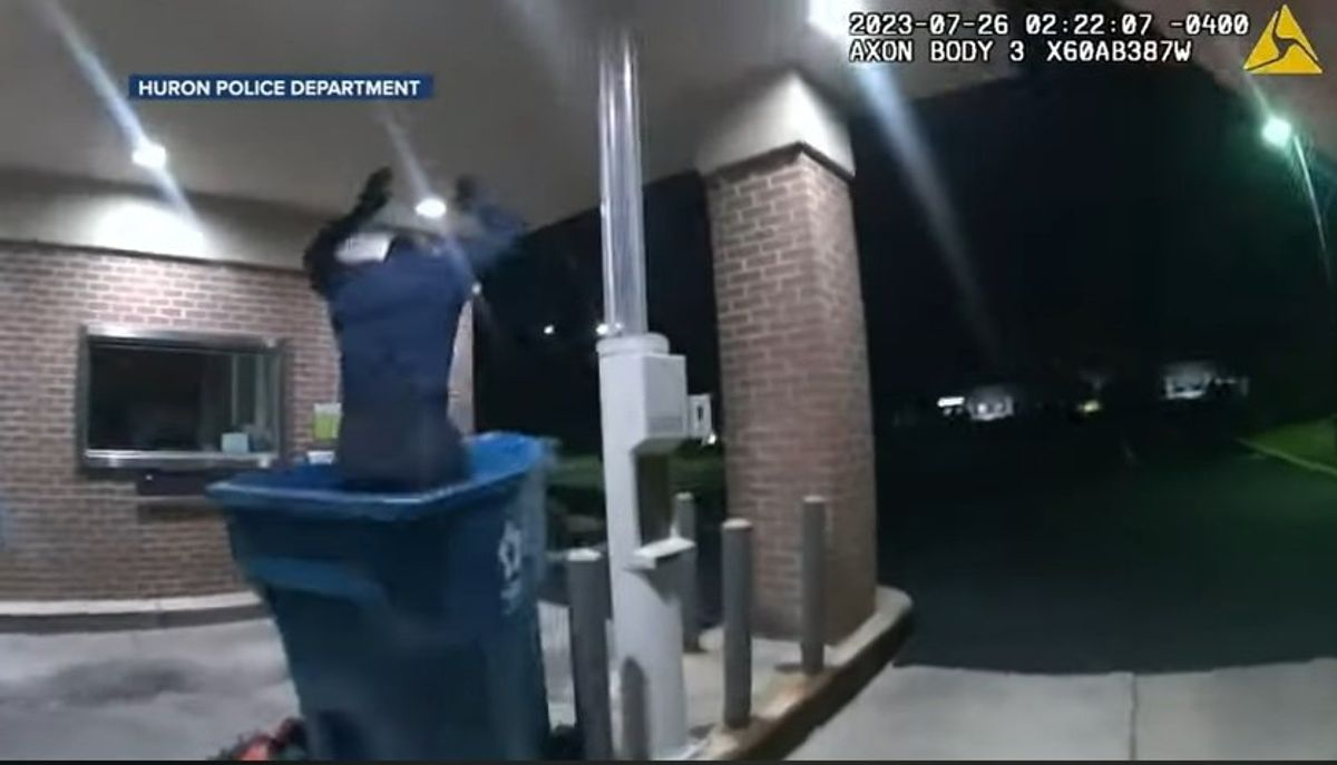 Watch: Video shows bumbling burglar fall from bank roof into trash can where cops are waiting