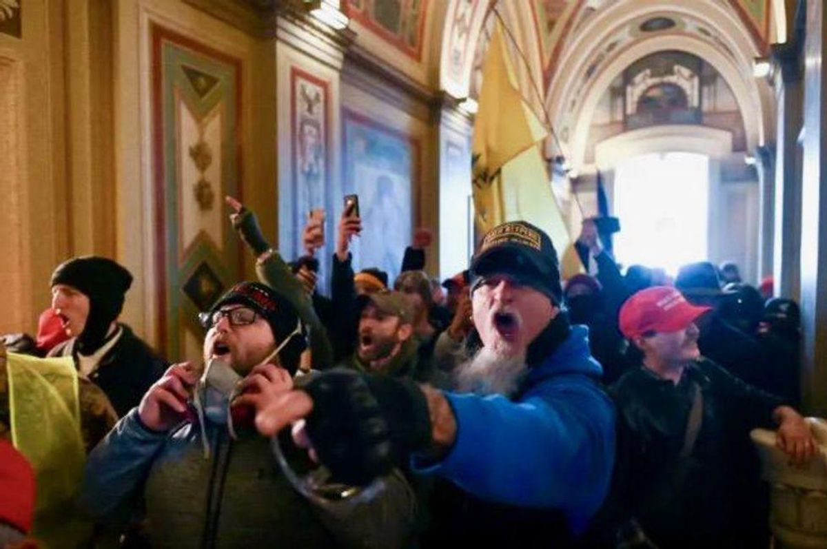 Photo shows GOP congressman barricading door to protect himself from the violent insurrectionists he likened to 'normal tourists'