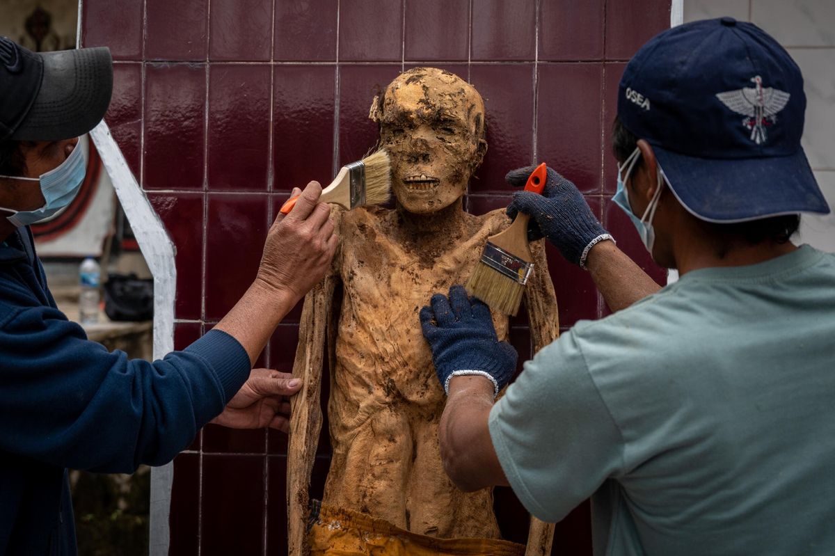 Indonesian villagers dress corpses in ritual for the dead