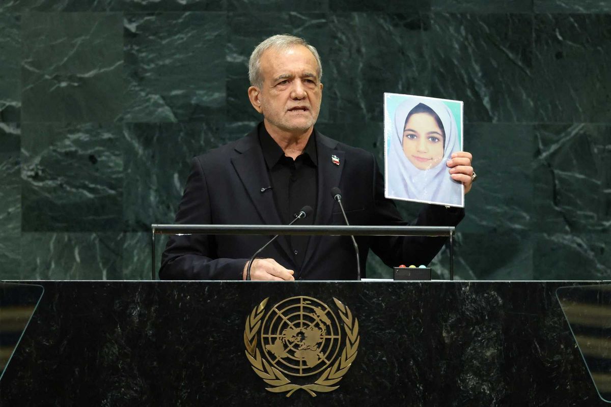 US delegation storms out as Iranian president holds up images of slain children