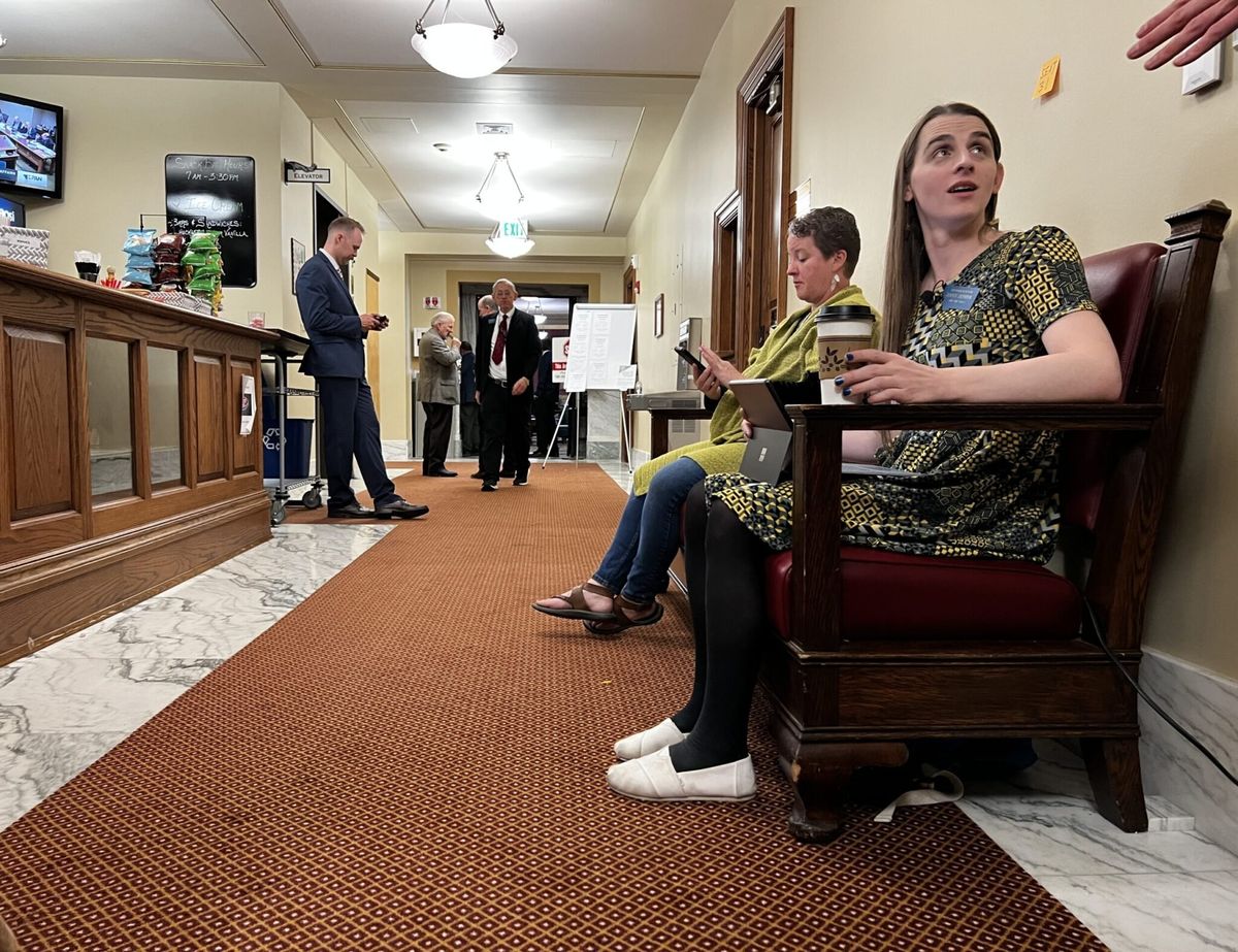 Banned transgender lawmaker working from bench outside Montana House floor