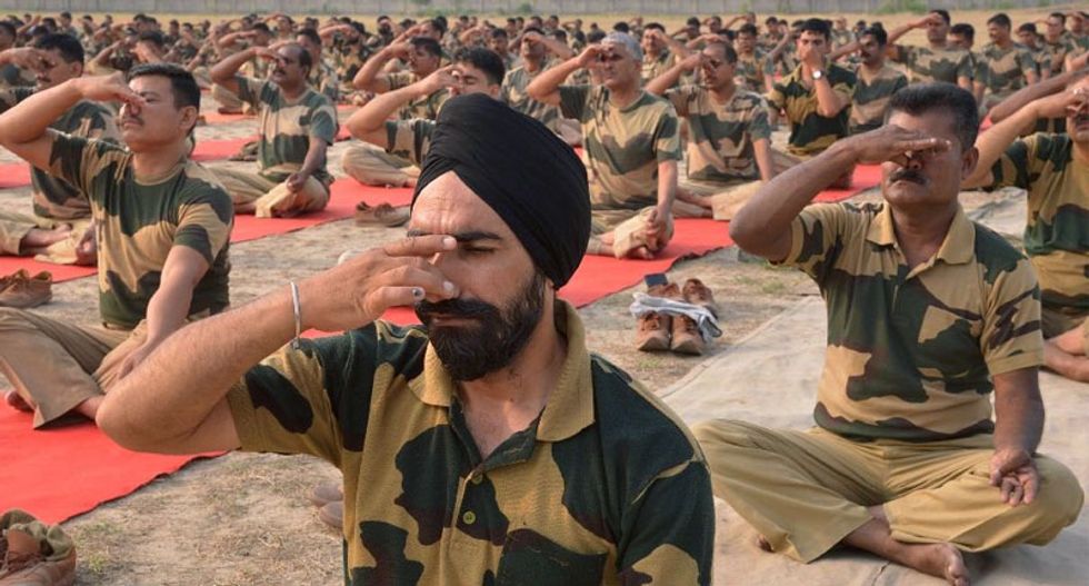 Millions stretch and bend for International Yoga Day