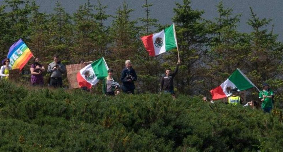 Protesters troll Trump by waving LGBT and Mexican flags on his Scottish golf course