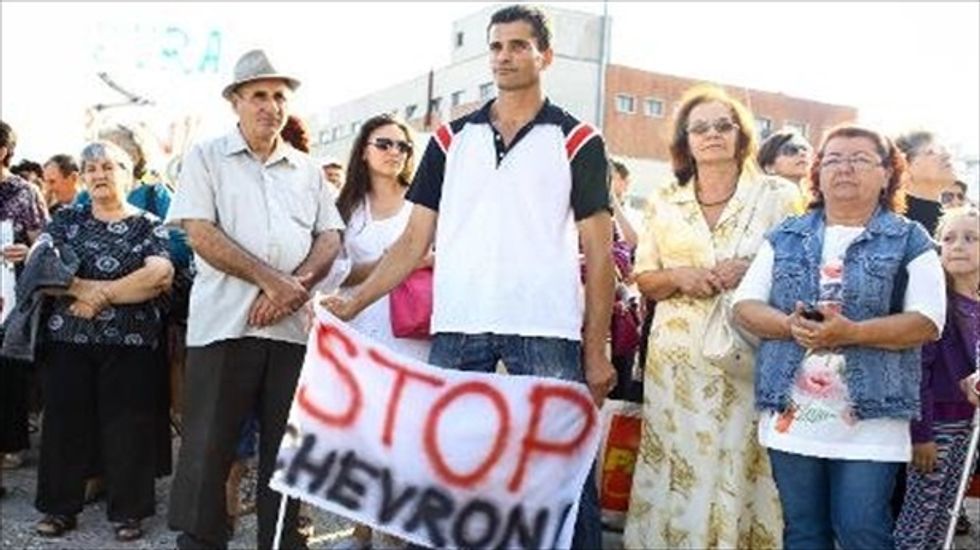 Romanian villagers and priests occupy Chevron fracking site in protest