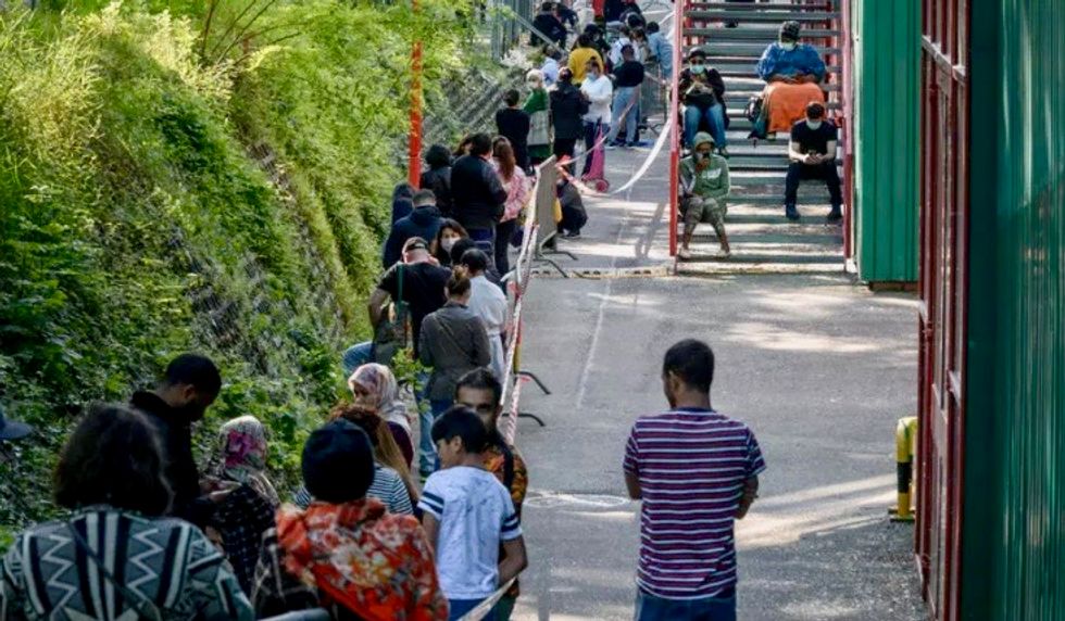 Crisis lays bare poverty in Geneva, Switzerland as thousands queue for food