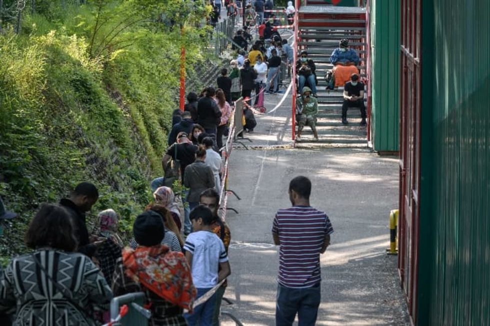 Crisis lays bare poverty in Geneva, as thousands queue for food
