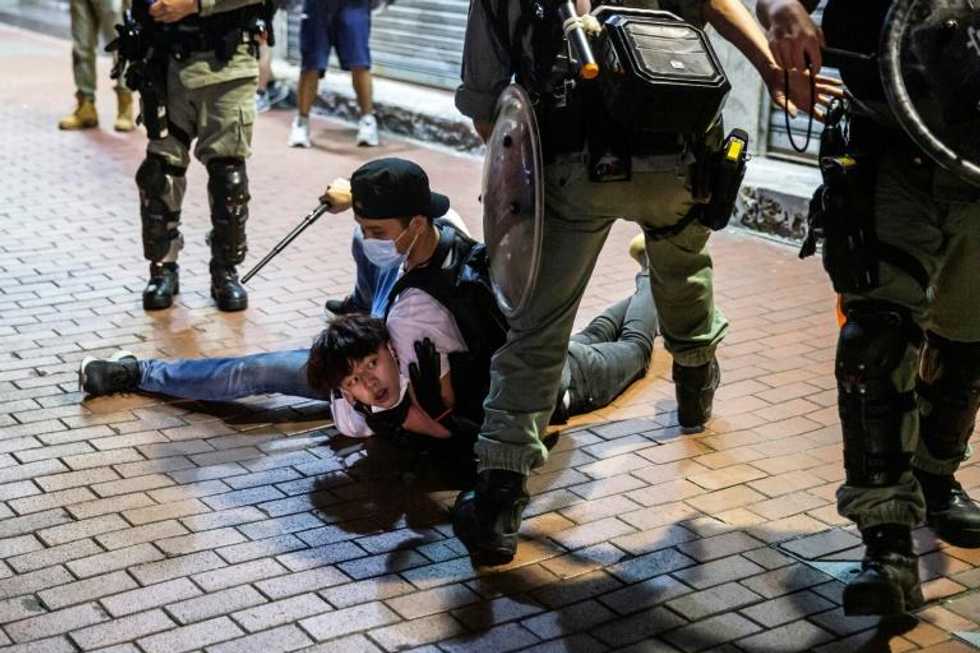 Riot police chase down Hong Kong Mother's Day protesters