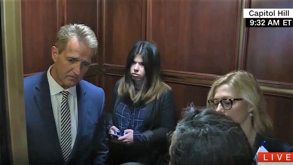 'Don't look away from me!' Watch furious women confront cowering Jeff Flake for supporting Brett Kavanaugh