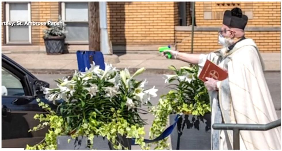 Priest goes viral for using squirt gun to bless parishioners with holy water