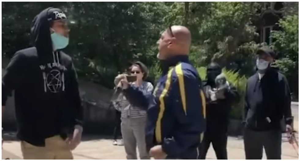 Ex-judge tries to slug protester during heated argument over Columbus statue