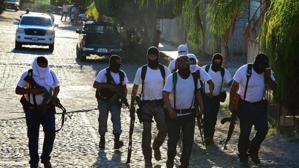 Armed citizens in more than 100 pick-up trucks seize Mexican town from drug cartel