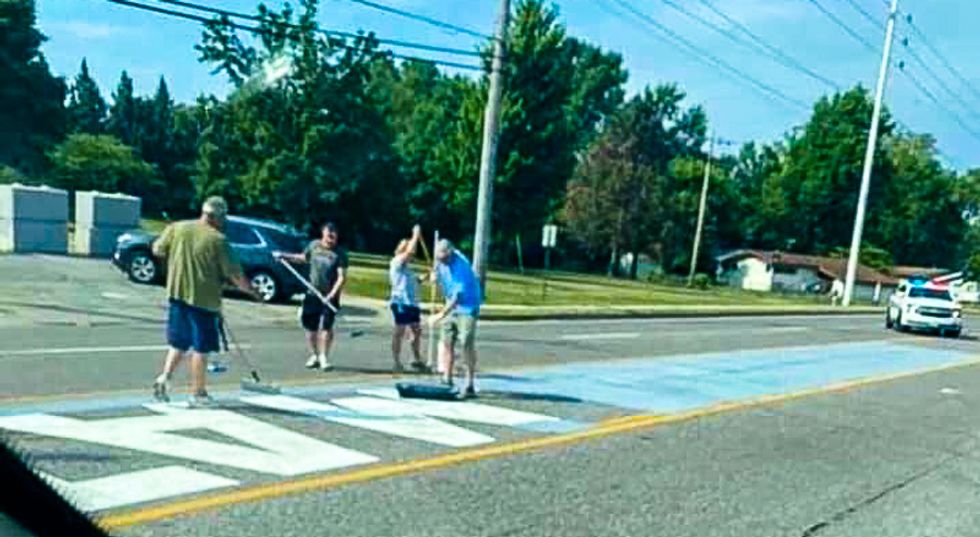 Missouri police stand guard as white people paint over Black Lives Matter mural with 'blue line'