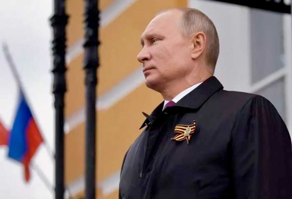 Putin reviews Red Square military parade on eve of vote that will keep him in power until 2036
