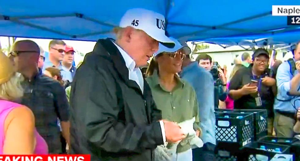 Trump complains hands are too big and rips off food service gloves while feeding Irma victims