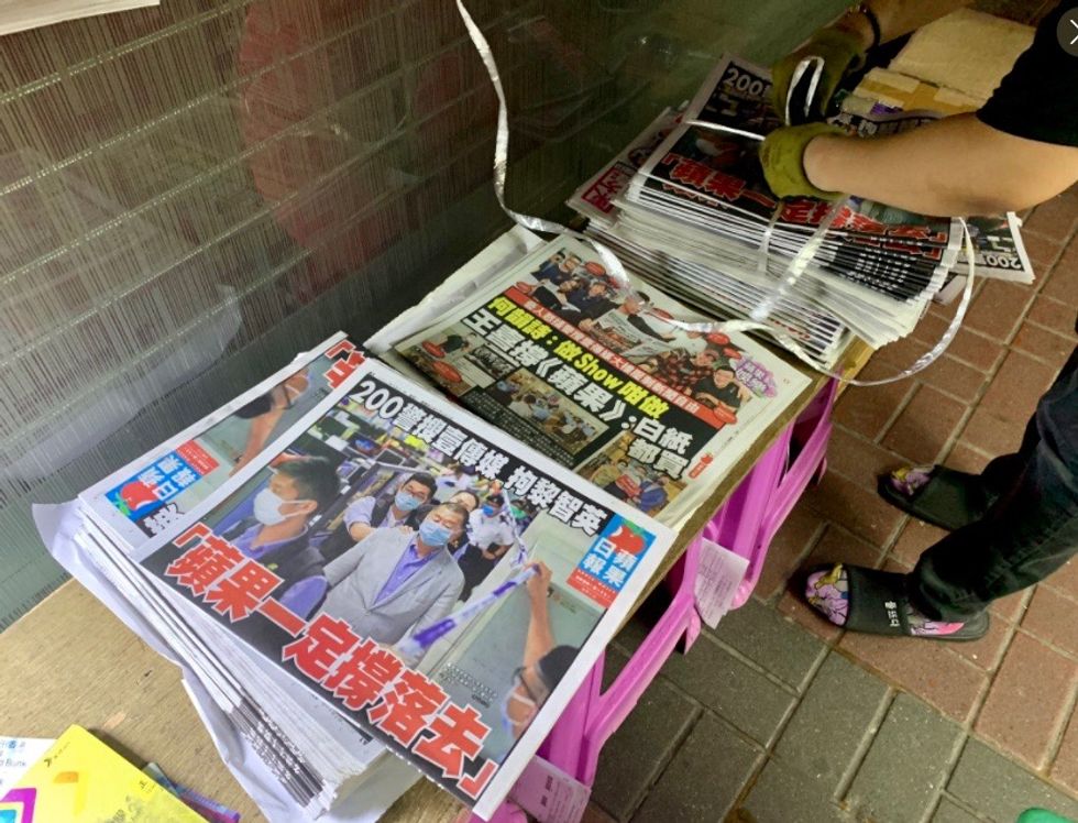 Hong Kongers defy China, rush to buy pro-democracy newspaper after owner's arrest