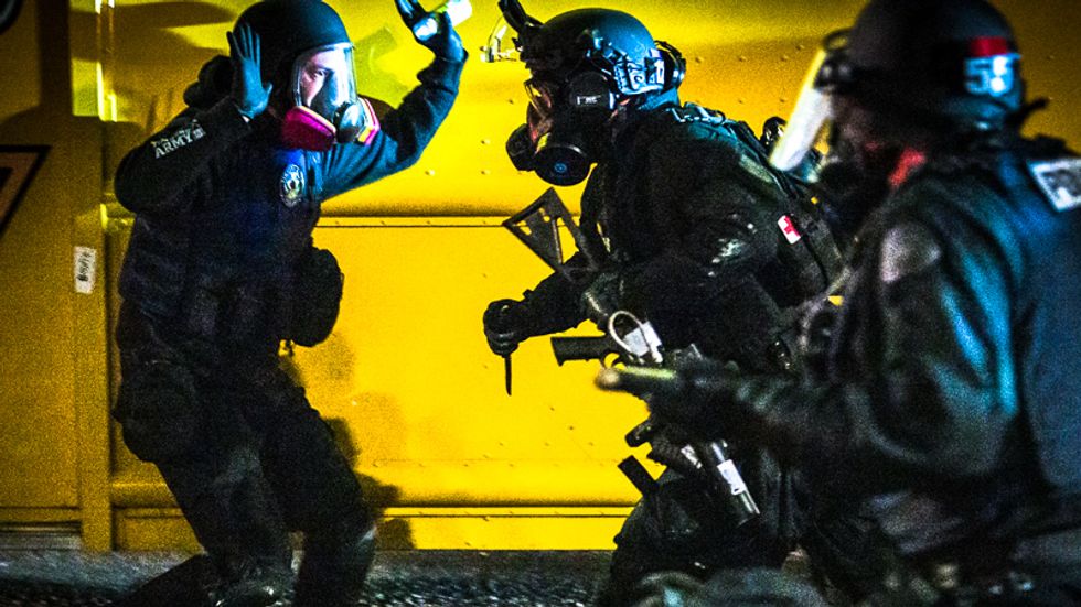 WATCH: Portland police in riot gear deploy teargas and then slash tires of medical van