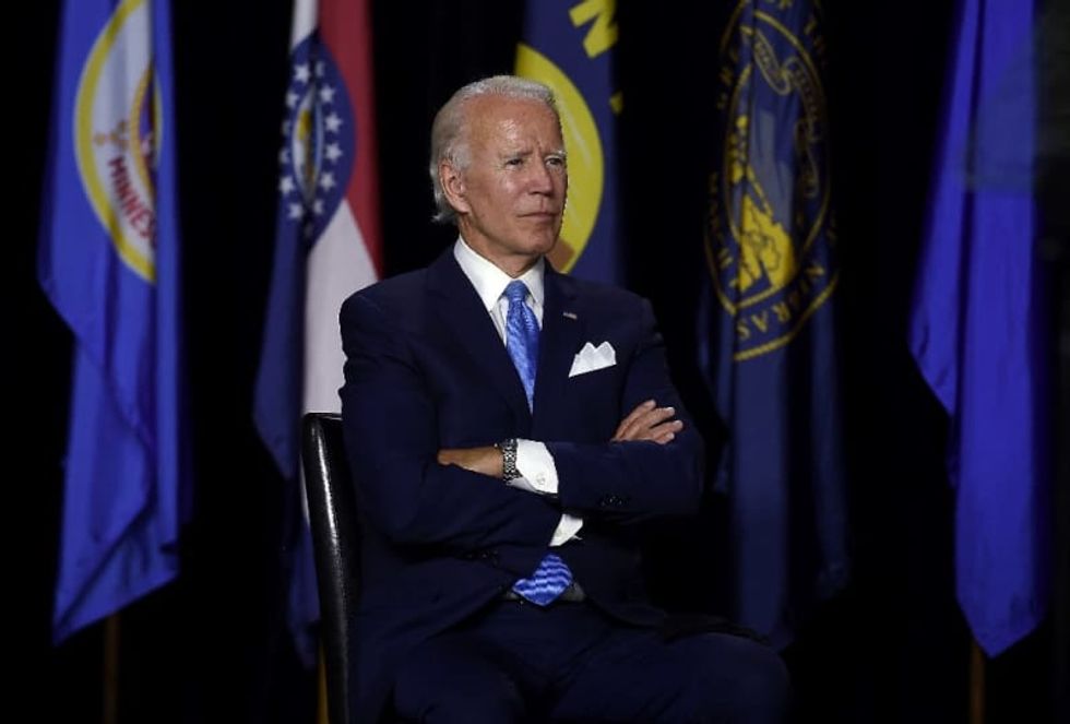 Trump grabs spotlight but reclusive Biden leads in the polls