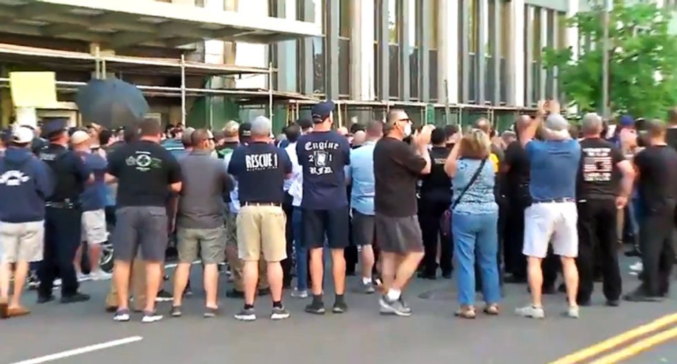 WATCH: Buffalo cops and firefighters cheer officers charged with assault as they leave the courthouse