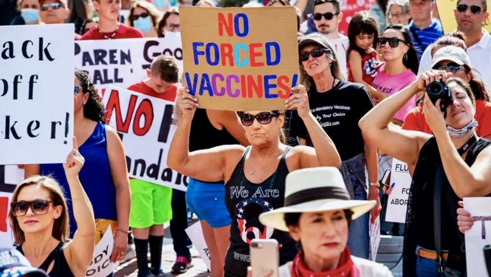 Anti-vax groups online are helping to radicalize the QAnon movement