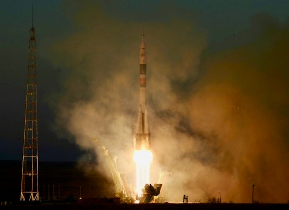 Soyuz arrives at ISS on first manned mission since October failure