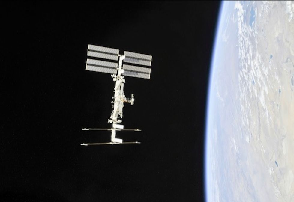 Russian spacewalkers take sample of mystery hole at space station