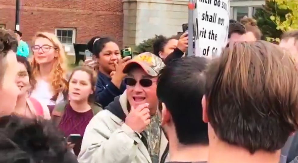 WATCH: Maine college students drown out anti-LGBTQ preacher by singing Elvis' 'I Can't Help Falling In Love With You'