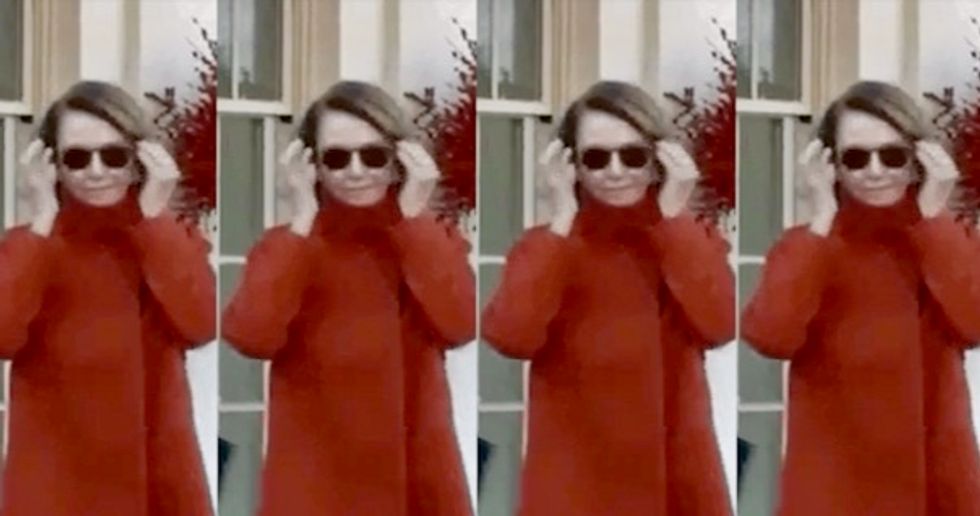 Activists project image of Nancy Pelosi in sunglasses walking away from exploding White House onto a federal building