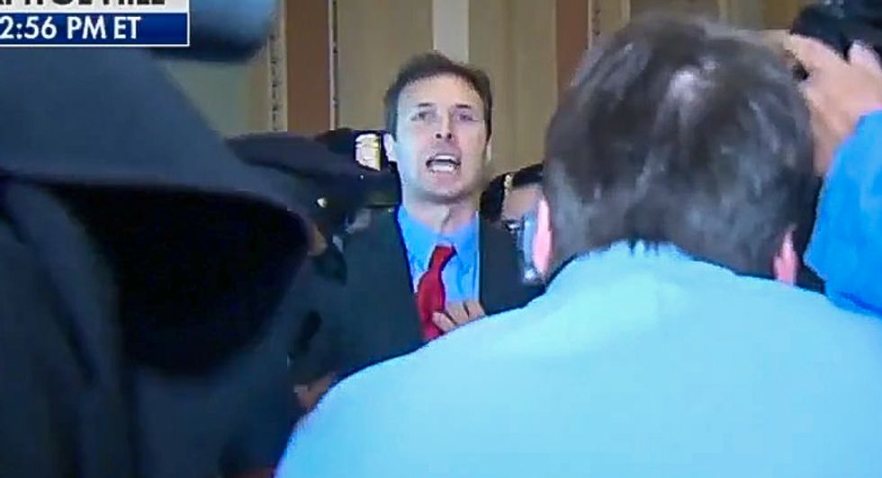 WATCH: Man screams 'Trump is treason' at president -- and tosses Russian flags at him