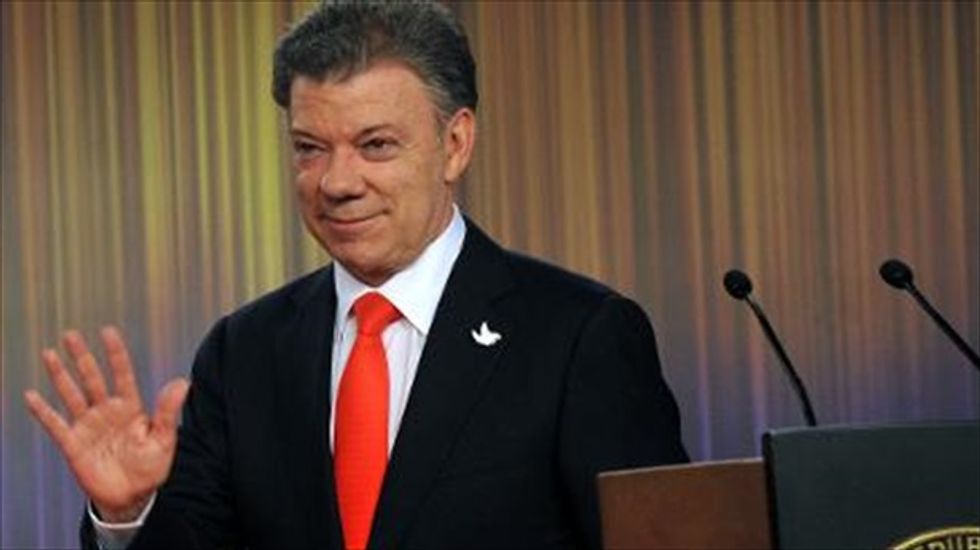 Colombia ready to resume peace negotiations after Santos wins re-election