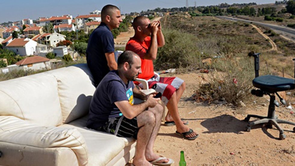 Israelis gather on hillsides to watch and cheer as military drops bombs on Gaza