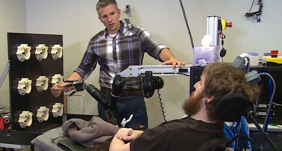 Paralyzed man feels touch through mind-controlled robot hand