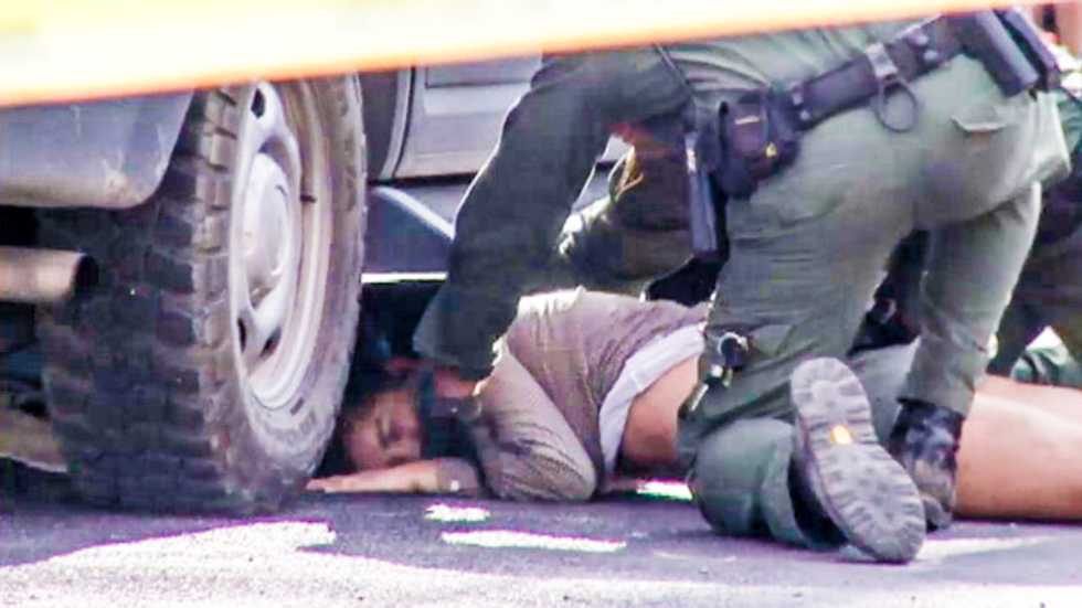 Activists swarm SB1070 'racial' citizenship check in Tucson, crawl under Border Patrol SUV