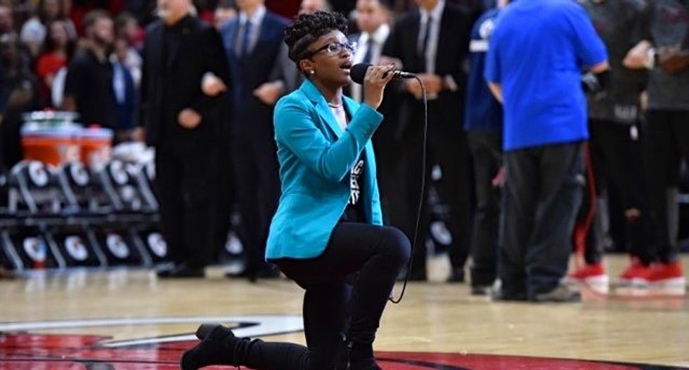 Singer kneels while performing anthem at Miami NBA game