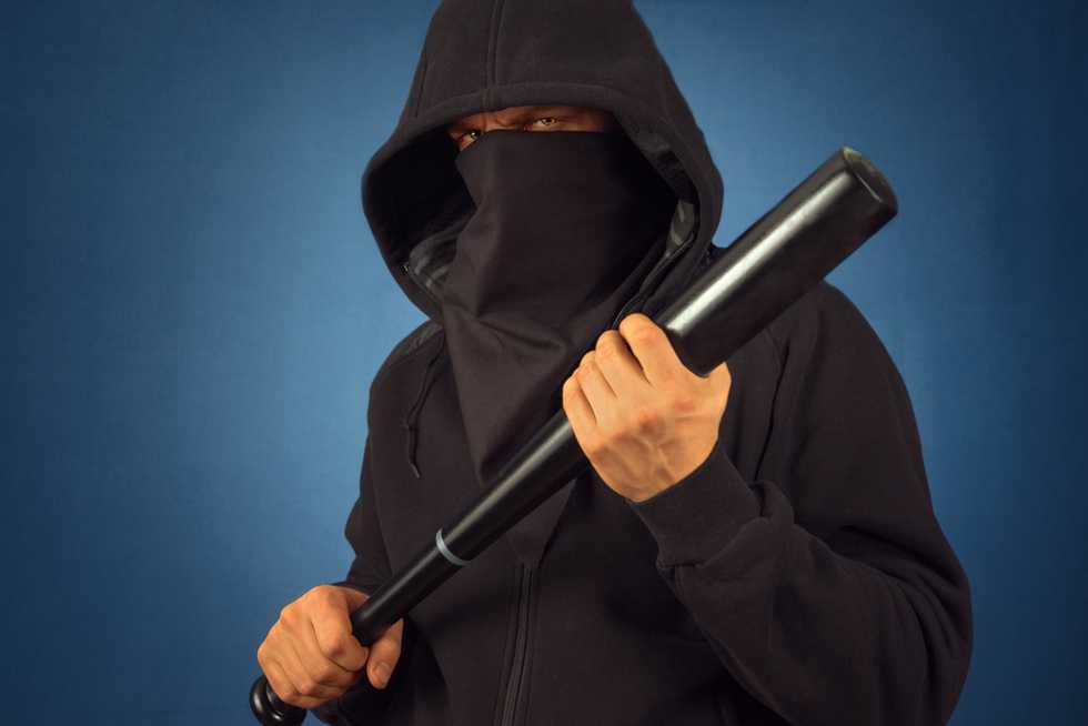 Masked California cop accused of beating woman with a baseball bat