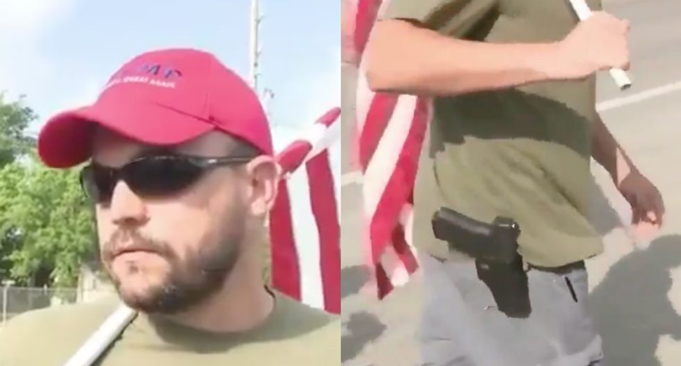 WATCH: Trump fan shows up at Texas high school shooting scene wearing a gun and waving a giant flag